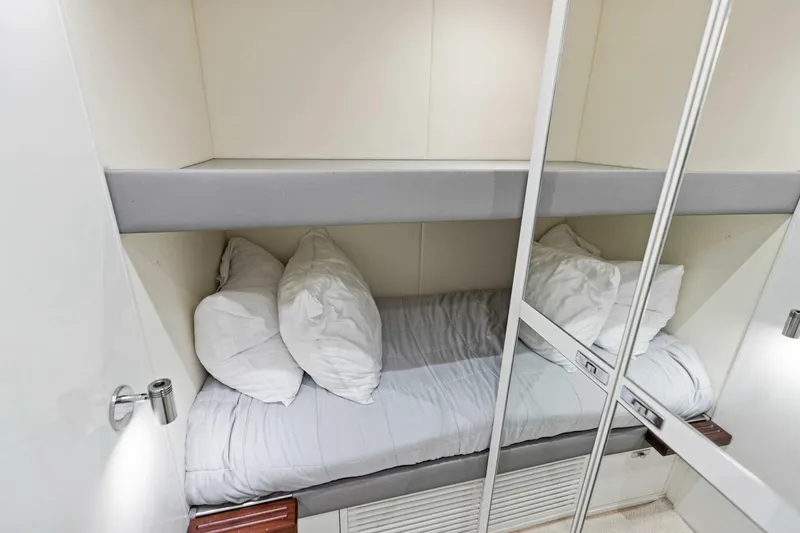 Lady Lion Yacht Photos Pics 2023 Princess X95 yacht cabin with bunk bed and mirrored closet.