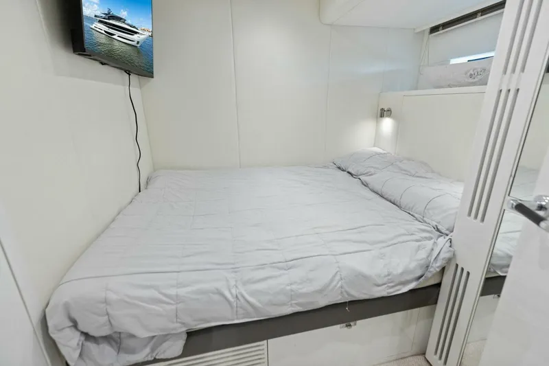 Lady Lion Yacht Photos Pics Luxurious bedroom interior of 2023 Princess X95 yacht with modern decor and wall-mounted TV.