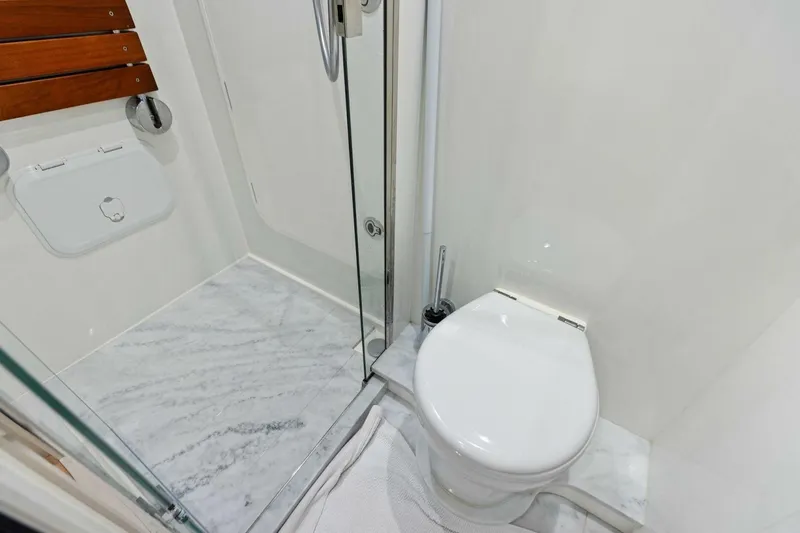 Lady Lion Yacht Photos Pics Modern bathroom on 2023 Princess X95 yacht with marble flooring and glass shower.