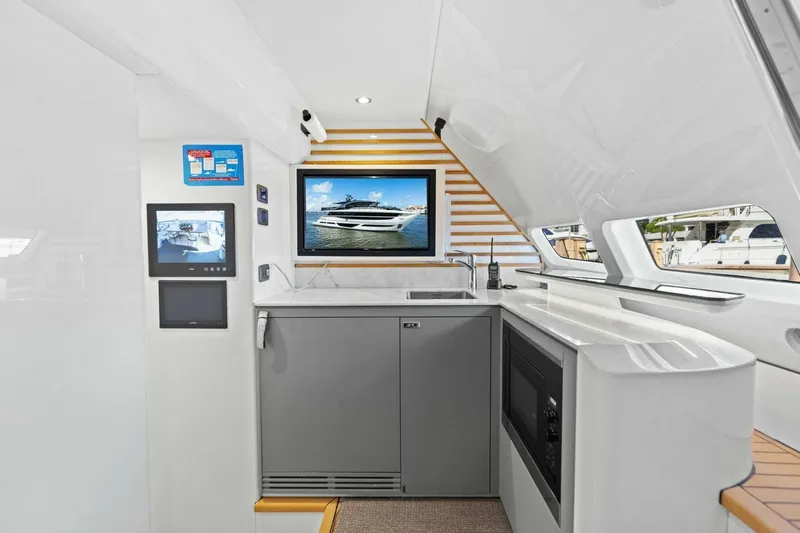 Lady Lion Yacht Photos Pics Luxurious interior of 2023 Princess X95 yacht with modern kitchen and entertainment screens.