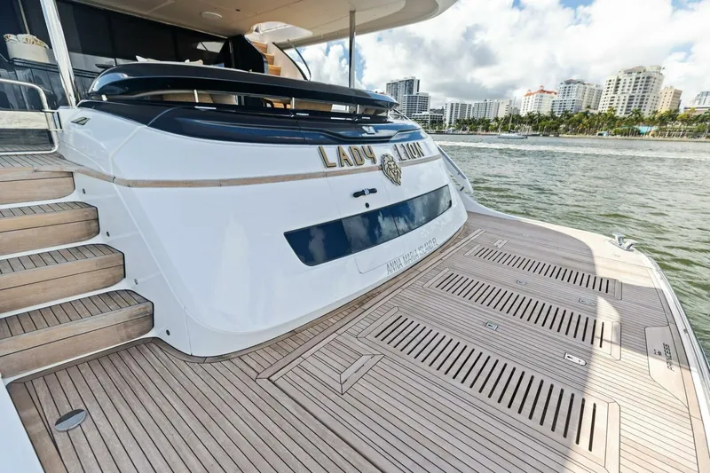 Lady Lion Yacht Photos Pics 2023 Princess X95 yacht with teak deck, docked near city skyline.