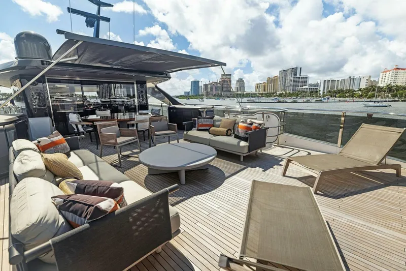 Lady Lion Yacht Photos Pics Luxurious 2023 Princess X95 yacht deck with elegant seating and waterfront city view.