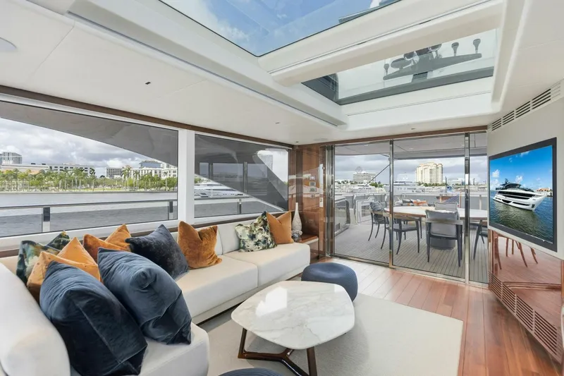 Lady Lion Yacht Photos Pics Luxurious 2023 Princess X95 yacht interior with elegant seating, large windows, and outdoor dining area.