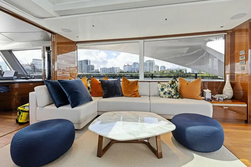 Lady Lion Yacht Photos Pics Luxurious interior of 2023 Princess X95 yacht with elegant seating and cityscape view.
