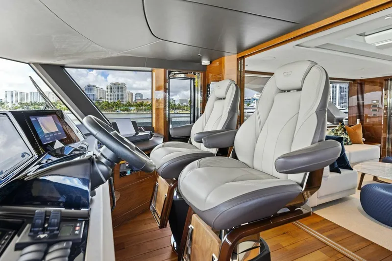 Lady Lion Yacht Photos Pics Luxurious 2023 Princess X95 yacht interior with plush captain's chairs and modern controls.