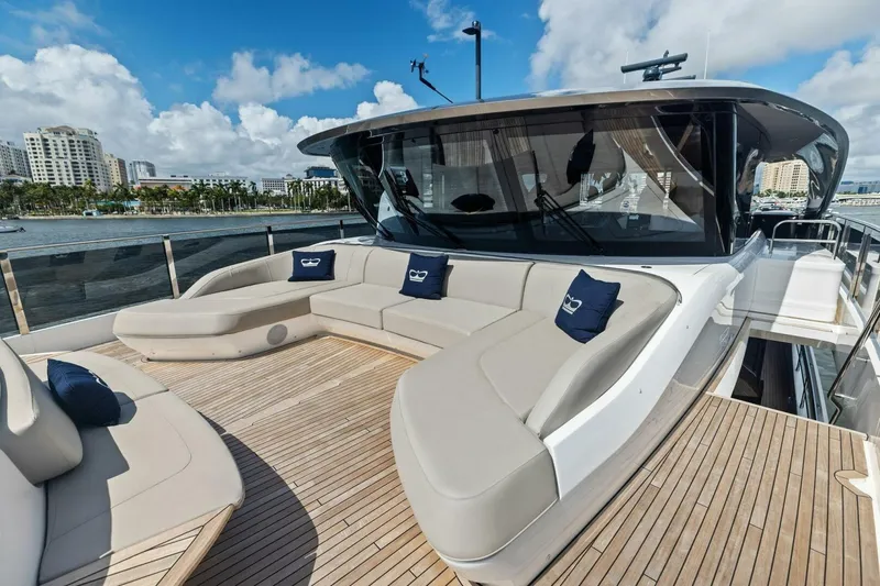 Lady Lion Yacht Photos Pics Luxurious 2023 Princess X95 yacht deck with plush seating and scenic waterfront view.