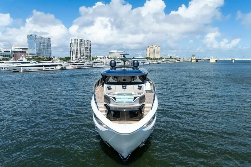 Lady Lion Yacht Photos Pics 2023 Princess X95 yacht docked in a marina with city skyline background.