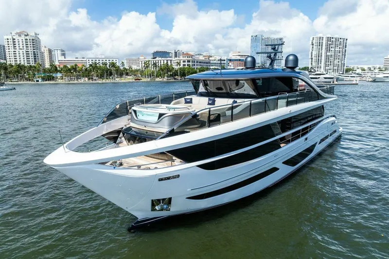 Lady Lion Yacht Photos Pics Luxurious 2023 Princess X95 yacht cruising in a scenic harbor setting.