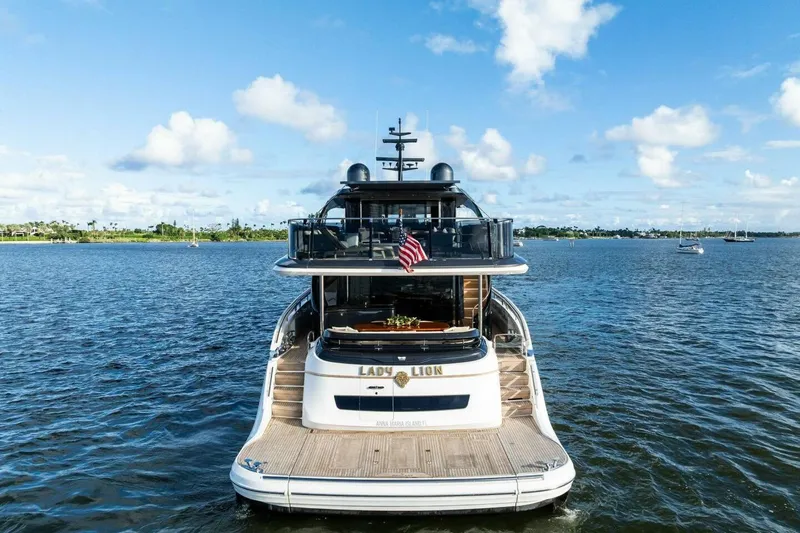 Lady Lion Yacht Photos Pics Luxurious 2023 Princess X95 yacht on serene water, featuring elegant design and American flag.