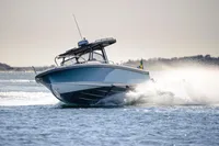 2023 Nimbus T9 X-Edition boat speeding on open water, creating a dynamic splash.