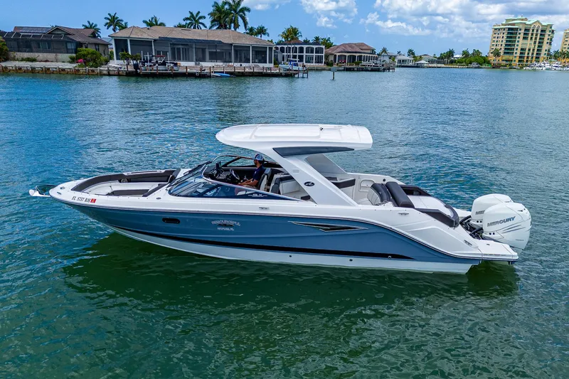  Yacht Photos Pics 2017 Sea Ray 31 SLX boat on calm water near waterfront homes.