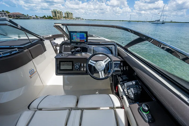  Yacht Photos Pics 2017 Sea Ray 31 SLX boat cockpit with steering wheel and navigation system.