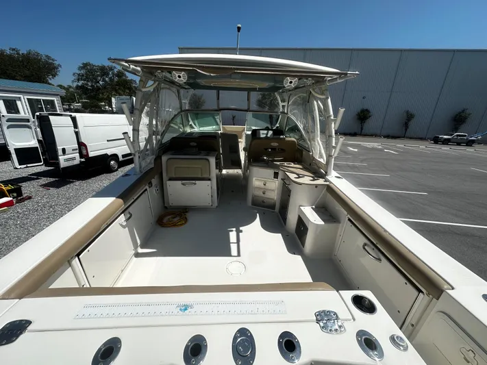  Yacht Photos Pics 2018 Sailfish 325DC boat interior, featuring spacious deck and seating under clear blue sky.