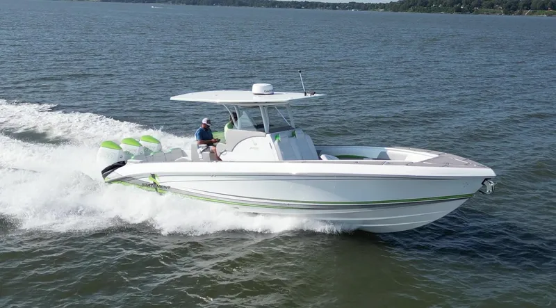  Yacht Photos Pics 2023 Statement 350 Open boat cruising on a lake with triple outboard engines.