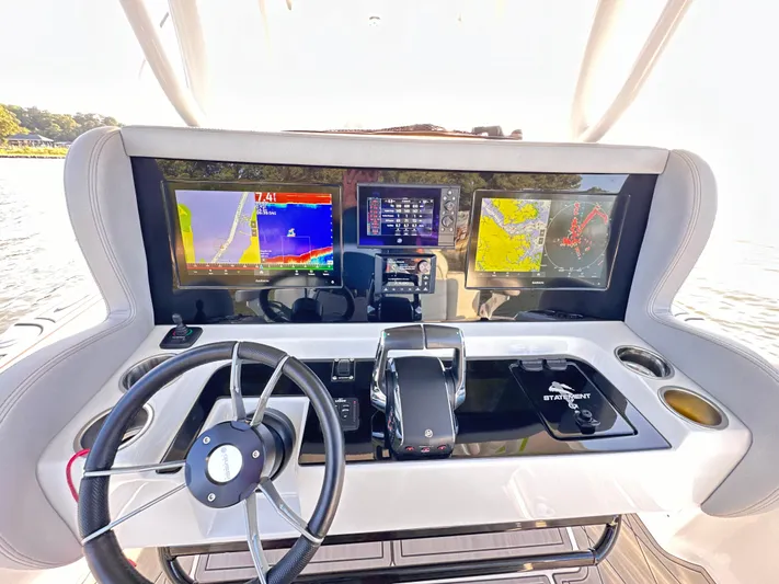  Yacht Photos Pics Control panel of 2023 Statement 350 Open boat with navigation screens and steering wheel.