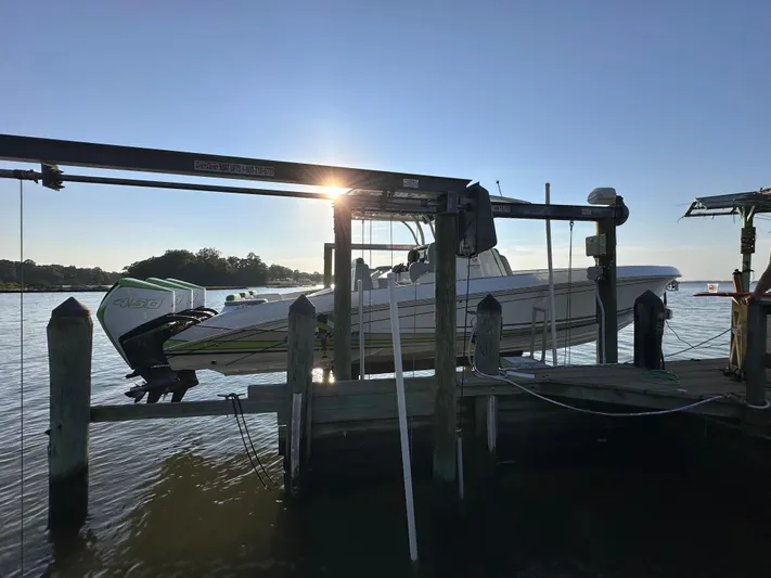  Yacht Photos Pics 2023 Statement 350 Open boat docked at sunset, with scenic water view.