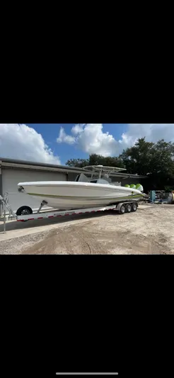  Yacht Photos Pics 2023 Statement 350 Open boat on trailer, parked outdoors under a partly cloudy sky.