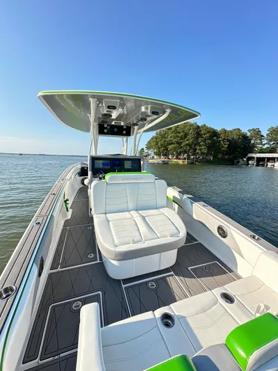  Yacht Photos Pics 2023 Statement 350 Open boat with sleek design, spacious seating, and modern features on a serene lake.