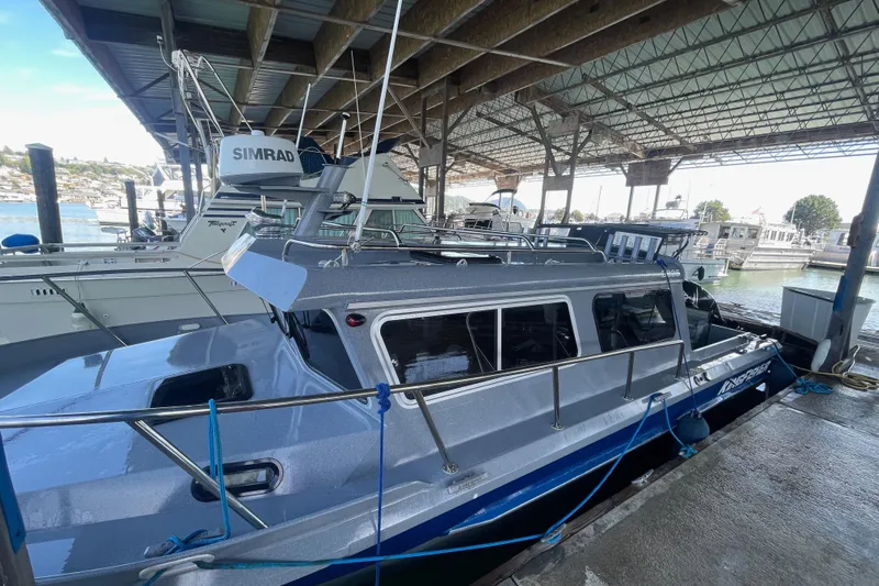  Yacht Photos Pics 2017 KingFisher 2825 Offshore boat docked under a covered marina.