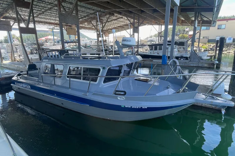  Yacht Photos Pics 2017 KingFisher 2825 Offshore boat docked in a marina under a covered structure.