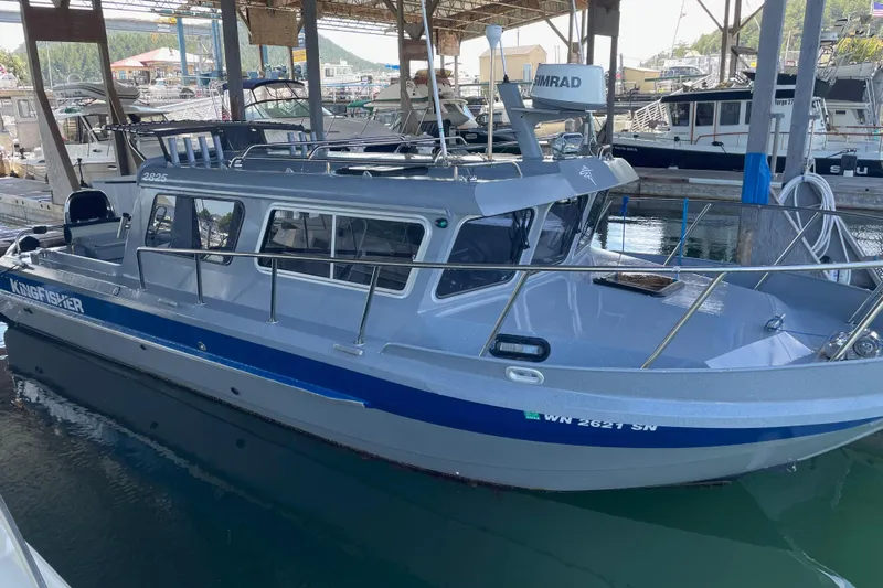  Yacht Photos Pics 2017 KingFisher 2825 Offshore boat docked in a marina under a covered area.
