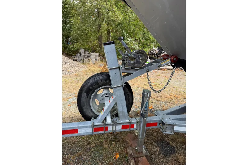  Yacht Photos Pics Trailer hitch and wheel of 2017 KingFisher 2825 Offshore boat, parked outdoors.