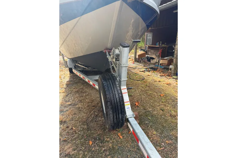  Yacht Photos Pics 2017 KingFisher 2825 Offshore boat on trailer, parked on grassy area.