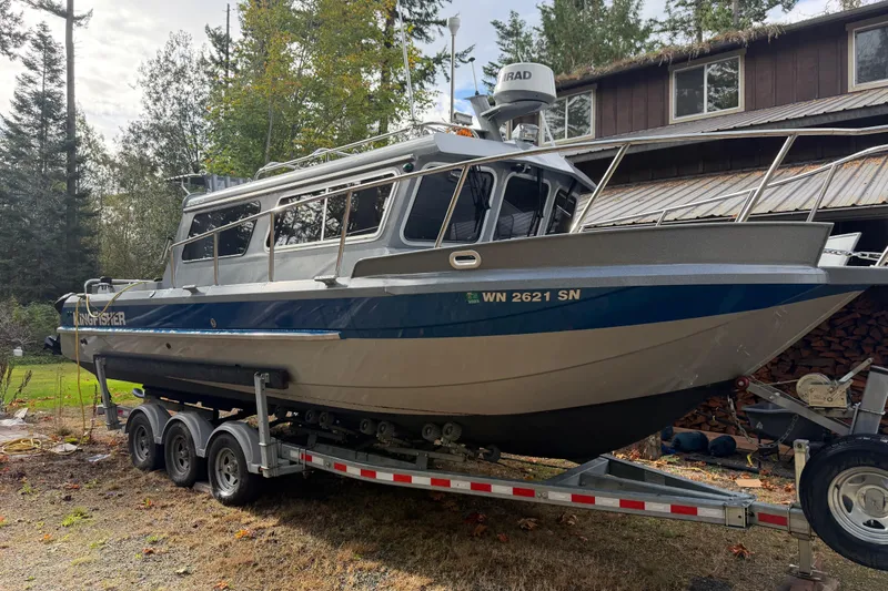  Yacht Photos Pics 2017 KingFisher 2825 Offshore boat on trailer, parked outdoors near a house.