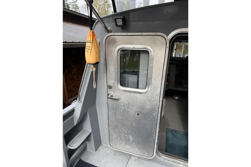  Yacht Photos Pics 2017 KingFisher 2825 Offshore boat door with rescue throw bag hanging nearby.