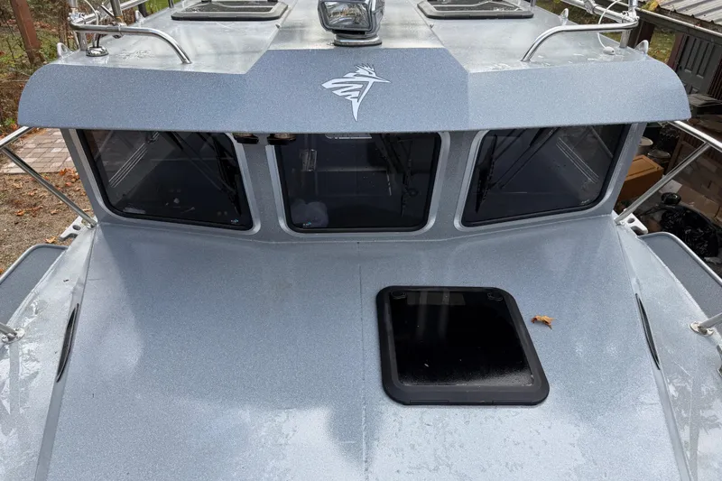  Yacht Photos Pics 2017 KingFisher 2825 Offshore boat, silver exterior, front view with windows and hatch.