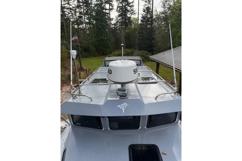  Yacht Photos Pics 2017 KingFisher 2825 Offshore boat with radar, docked near forested area.