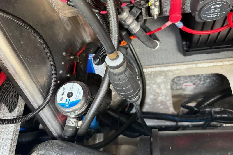  Yacht Photos Pics Engine compartment of a 2017 KingFisher 2825 Offshore boat, showing wiring and pump components.