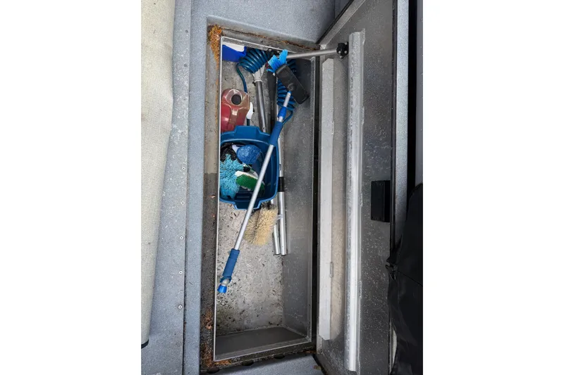  Yacht Photos Pics Storage compartment on a 2017 KingFisher 2825 Offshore boat with cleaning tools.