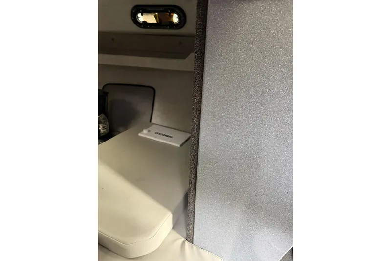  Yacht Photos Pics Interior of 2017 KingFisher 2825 Offshore boat cabin with seating and window.