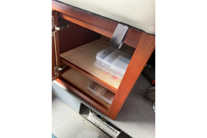  Yacht Photos Pics Wooden storage cabinet with plastic containers inside a 2017 KingFisher 2825 Offshore boat.