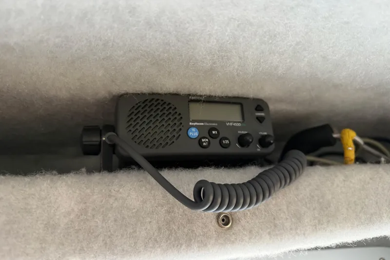  Yacht Photos Pics VHF radio installed in a 2017 KingFisher 2825 Offshore boat, featuring coiled microphone cable.