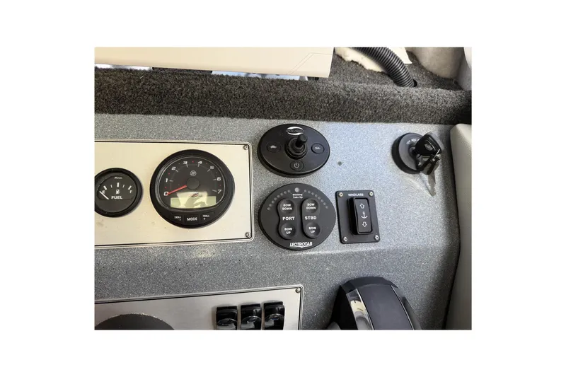  Yacht Photos Pics Dashboard controls of a 2017 KingFisher 2825 Offshore boat, featuring gauges and switches.