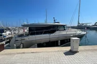 2019 Cranchi T36 Crossover yacht docked at a marina under clear blue skies.