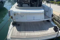 2019 Cranchi T36 Crossover yacht docked, rear view with teak deck and mooring lines.