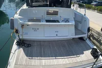 2019 Cranchi T36 Crossover yacht docked, featuring spacious rear deck and outdoor kitchen.