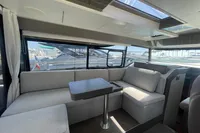 2019 Cranchi T36 Crossover interior with modern seating and table, featuring large windows.