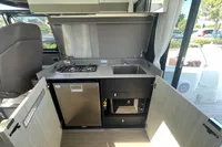 2019 Cranchi T36 Crossover yacht kitchen with stove, sink, and fridge.