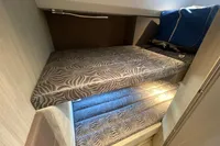2019 Cranchi T36 Crossover cabin with patterned bunk beds and cozy interior.
