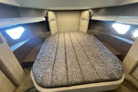 Luxurious cabin interior of 2019 Cranchi T36 Crossover with elegant bedding and ambient lighting.