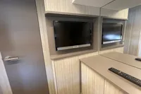 2019 Cranchi T36 Crossover interior with mounted TV and modern cabinetry.