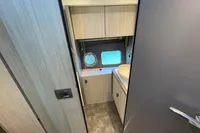 2019 Cranchi T36 Crossover bathroom interior with modern cabinetry and porthole window.