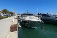 2019 Cranchi T36 Crossover yacht docked at a marina under clear blue skies.