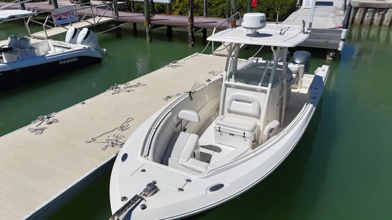  Yacht Photos Pics 2015 Sailfish 290cc boat docked in marina, featuring sleek design and spacious seating.