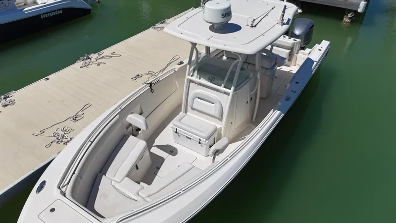  Yacht Photos Pics 2015 Sailfish 290cc boat docked on calm green water.