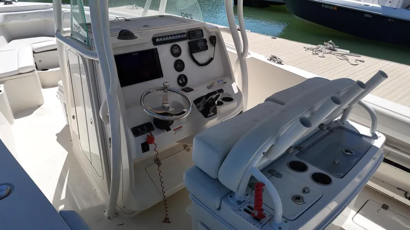  Yacht Photos Pics 2015 Sailfish 290cc boat cockpit with steering wheel, control panel, and seating.